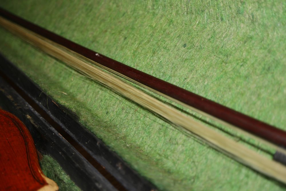 A late 19th century European violin with inlaid decoration, cased with bow, Joseph Guanaris label to interior of violin